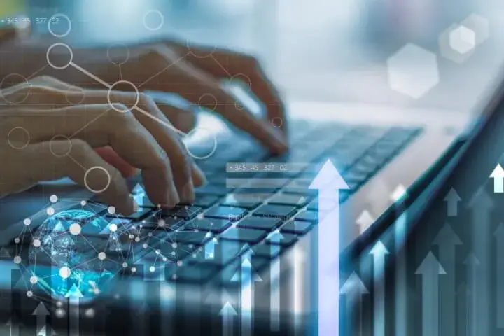 Hands typing on a laptop keyboard with upward arrows and data visualizations in the background, symbolizing growth and success through social analysis.